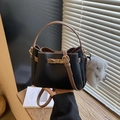 Chic black and brown leather bucket bag with litchi texture and gold lock hardware - With Charm / Classic Black