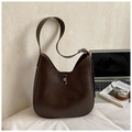 Deep brown retro Hobo shoulder bag with silver clasp in a lifestyle workspace setting - Brown