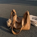 Vintage brown leather tote bag with teddy bear charm and adjustable strap outdoors - With Charm / Brown