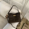 Detail of dark brown matte tote bag with golden lock, white stitching and monkey charm - Coffee with Pendant