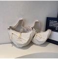 Detail view of large minimalist cream canvas crescent bags with wide adjustable straps - L / Off White