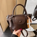 Dark brown faux leather crossbody bag with wooden bead charm and top handles - Brown