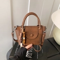 Retro brown faux leather crossbody bag with wooden beads and top handle detail - Brown