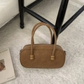 Brown suede handbag with ball charm detail and metal zipper on white plush carpet - Brown No Pendant