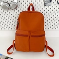 Minimalist deep orange nylon backpack featuring multiple front pockets and durable straps - Orange