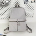 Minimalist light grey nylon backpack with dual front pockets for travel and school use - Gray