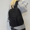 Minimalist black nylon travel backpack for men and women featuring dual front zip pockets - Black