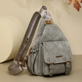 Detailed close-up of grey soft PU leather chest bag with bronze hardware and logo - Gray