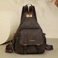 Detailed view of dark brown soft leather backpack with gold metal buckles and vintage texture - Coffee