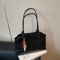 Retro black tote bag featuring mixed textures, knotted strap, and colorful bead charm - Black
