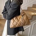 Caramel brown quilted rhombic shoulder bag with woven pendant and fringe detail - With Charm / Brown