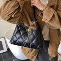 Quilted black shoulder bag with a yellow smiley charm and brown leather pendant - With Charm / Black