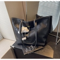 Close-up of black tote bag with white contrast stitching and fluffy cloud charm accessory - With Pendant / Black