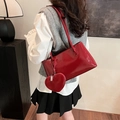 Glossy red faux leather tote bag with heart charm and embossed logo on shoulder - Red