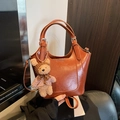 Brown leather bucket bag with teddy bear charm and adjustable shoulder strap - With Charm / Yellow Brown