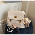Detail of cream backpack with gold turn-lock closure and cute plush bear charm - Beige With Charm