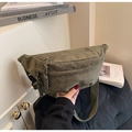 Close-up of military green corduroy chest bag with woven rope zipper detail - Green