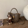 Detail of dark brown pebble leather bucket bag with teddy bear charm and gold clasp - With Pendant / Elephant Gray