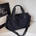 Large black nylon travel duffel bag with dual handles and adjustable shoulder strap - Black
