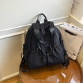 Minimalist black nylon backpack with drawstring side pockets and dual zipper compartments - Black