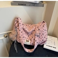 Macro view of pink corduroy tote bag with black heart patterns and plush bear charm - Pink with Pendant
