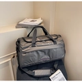 Detail of high-capacity travel bag featuring water-resistant fabric and reinforced handles - Gray