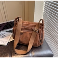 Detail of brown corduroy tote bag showing multiple zipper pockets and wide canvas strap - Coffee
