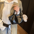 Black pleated leather tote with gold buckle and white plush bunny charm accessory - With Charm / Black