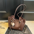 Chic brown leather tote bag with ice cream pendant and tassel on black textured background - Caramel (With Charm)