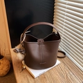 Brown litchi leather bucket bag with leopard pompom and crossbody strap on book - With Pendant / Brown