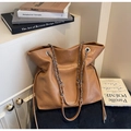 Macro detail of caramel brown tote bag with metal chain strap and drawstring accents - Khaki