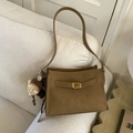 Vintage brown matte shoulder bag with gold buckle and a cute bear charm on sofa - With Charm / Caramel color
