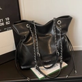 Glossy black leather tote bag with silver chain straps and drawstring detail - Black