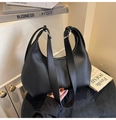 Detail of black lychee grain leather hobo bag featuring silver ring buckle hardware - Black