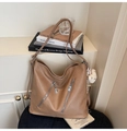 Detail view of khaki PU leather hobo bag with zip accents and cute plush bear charm - Khaki