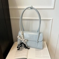 Elegant light blue glossy shoulder bag with a decorative bow charm on a book - No Pendant / Blue