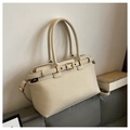 Close-up of off-white tote bag with lychee grain leather and golden metal buckle details - Off White
