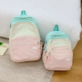 Detail view of macaron color-block canvas backpacks in two sizes for family or travel - Large / Pink