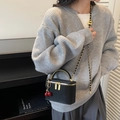 Black woven leather box bag with gold chain and cherry charm shown on model - Black with Pendant