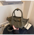 Detail of olive green suede tote bag featuring quilted patterns and metal buckle hardware - Green