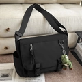 Black large messenger bag in water-resistant canvas with green dinosaur pendant - With Charm / Black