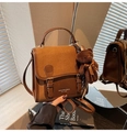 Detail of vintage contrast color shoulder bag with plush bear charm and brand logo - With Charm / Brown