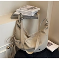 Detailed close-up of cream beige dumpling bag with soft pleats and smooth zipper closure - Khaki