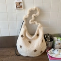 Detail of white plush shoulder bag featuring embroidered stars and thick textured strap - Off-white