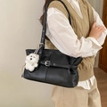 Black pebbled leather tote bag with silver hardware and a white plush puppy charm - Black