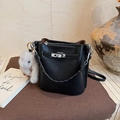 Detail of black pebbled leather bucket bag with silver twist lock and bunny charm - With Charm / Black