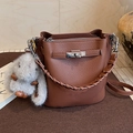 Brown litchi grain leather bucket bag with silver padlock and plush rabbit charm - With Charm / Brown