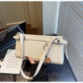 Detail of cream baguette bag with smooth leather finish and cute brown fur pompom accessory - Off-white