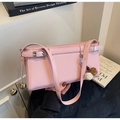 Detail of pink baguette shoulder bag with adjustable strap and plush charms - Pink