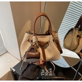Canvas and brown leather bucket bag featuring a mini pouch charm and crossbody strap - With Charm / Brown